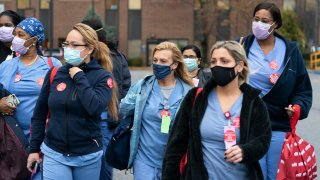 Nurses walk out of Montefiore New Rochelle Hospital to go on strike over safe staffing issues during the coronavirus pandemic, Tuesday, Dec. 1, 2020, in New Rochelle, N.Y.