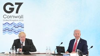British Prime Minister Boris Johnson (L) and US President Joe Biden (R) attend a working session at the G7 summit in Carbis Bay, Cornwall on June 12, 2021. - G7 leaders from Canada, France, Germany, Italy, Japan, the UK and the United States meet this weekend for the first time in nearly two years, for three-day talks in Carbis Bay, Cornwall.