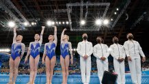 Russian Olympic Committee's artistic gymnastics women's team, Angelina Melnikova, Vladislava Urazova, Liliia Akhaimova and Viktoriia Listunova, wave standing next to United States' artistic gymnastics women's team, from right, Sunisa Lee, Simone Biles, Jordan Chiles, and Grace McCallum prior to the artistic gymnastics women's final 2020 Summer Olympics, Tuesday, July 27, 2021, in Tokyo.