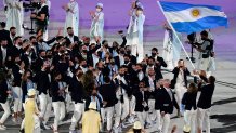 Cecilia Carranza Saroli and Santiago Raul Lange, of Argentina, right, carry their country's flag during the opening ceremony in the Olympic Stadium as Team Argentina sings at the 2020 Summer Olympics, Friday, July 23, 2021, in Tokyo, Japan.