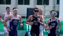 Alex Yee of Great Britain leads a group including Hayden Wilde of New Zealand, center, and Kevin McDowell of United States, left, during the run portion of the men's individual triathlon at the 2020 Olympics on July 26, 2021, in Tokyo, Japan.