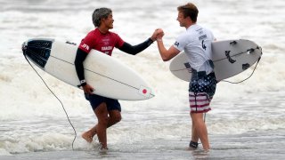 Japan's Kanoa Igarashi, left, shake hands with Kolohe Andino, of the United States, after wining the quarterfinals of the men's surfing competition at the 2020 Summer Olympics, Tuesday, July 27, 2021, at Tsurigasaki beach in Ichinomiya, Japan.