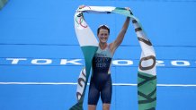 Flora Duffy of Bermuda celebrates after crossing the finish line to win the gold medal in the women's individual triathlon competition at the 2020 Olympics on July 27, 2021, in Tokyo, Japan.