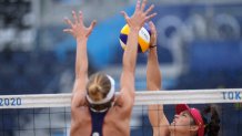 Elsa Baquerizo McMillan, of Spain, right, of Spain, takes a shot as Alix Klimeman, of the United States, defends during a women's beach volleyball match at the 2020 Olympics on July 27, 2021, in Tokyo, Japan.