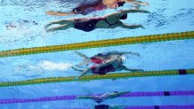 United States' Regan Smith, top, swims to win the bronze medal in the 100-meter backstroke final at the 2020 Olympics on July 27, 2021, in Tokyo.