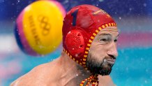 Spain's goalkeeper Daniel Lopez Pinedo tries to block a shot that sails past for a goal during a preliminary round men's water polo match against Montenegro at the 2020 Olympics on July 27, 2021, in Tokyo, Japan.