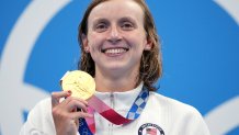 Katie Ledecky of the United States poses with her gold medal after winning the women's 1500-meters freestyle final at the 2020 Summer Olympics, Wednesday, July 28, 2021, in Tokyo, Japan.