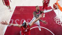 United States' Damian Lillard (6) shoots over Iran's Mohammadsina Vahedi (3) during a men's basketball preliminary round game at the 2020 Summer Olympics, Wednesday, July 28, 2021, in Saitama, Japan.