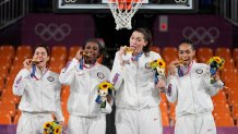 From left: Members of Team USA Kelsey Plum, Jacquelyn Young, Stefanie Dolson and Allisha Gray pose with their gold medals during the awards ceremony for women's 3-on-3 basketball at the 2020 Summer Olympics, Wednesday, July 28, 2021, in Tokyo, Japan. They became the first Olympians to win a gold medal in the women's 3x3 basketball category.