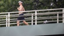 A man runs down a bridge during Tropical Storm Elsa