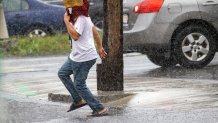 A person runs for shelter from the rain