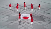 The Japanese National Flag is carried out during the opening ceremony of the Tokyo 2020 Olympic Games at the Olympic Stadium in Tokyo, July 23, 2021.