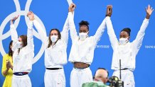 Bronze medallists (from L) USA's Erika Brown, USA's Abbey Weitzeil, USA's Natalie Hinds and USA's Simone Manuel pose on the podium after the final of the women's 4x100m freestyle relay swimming event during the Tokyo 2020 Olympic Games at the Tokyo Aquatics Centre in Tokyo on July 25, 2021.