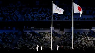 The Olympic flag is raised alongside the Japanese flag during the Opening Ceremony of the Tokyo 2020 Olympic Games at Olympic Stadium on July 23, 2021 in Tokyo, Japan.