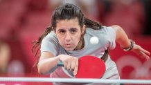 Twelve year old Hend Zaza of Syria, the youngest competitor in the Olympic Games in Tokyo, plays against Jia Liu of Austria in the Women's Singles Preliminary Round at the Tokyo Olympic Games, July 24, 2021.