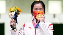 Gold medalist Yang Qian of China celebrates on the podium after the 10m Air Rifle Women's Final on the first day of the Tokyo 2020 Olympic Games at the Asaka Shooting Range on July 24, 2021, Saitama, Japan. Yang was the first to win a gold medal in Tokyo.