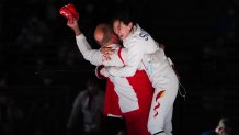 Sun Yiwen of China celebrates with her coach Hugues Obry after winning the Women's Epee Individual gold medal bout of the fencing on day one of the Tokyo 2020 Olympic Games at Makuhari Messe Hall on July 24, 2021, in Chiba, Japan.