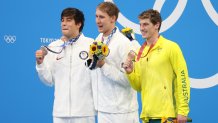 Gold medalist Chase Kalisz of USA, silver medalist Jay Litherland of USA and bronze medalist Brendon Smith of Australia hold up their medals during the medals ceremony of the 400m individual medley final on day two of the Tokyo 2020 Olympic Games at Tokyo Aquatics Centre on July 25, 2021 in Tokyo, Japan.