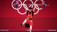 Li Fabin of Team China competes in the Men's 61kg Weightlifting Group A match on day two the Tokyo 2020 Olympic Games at the Tokyo International Forum on July 25, 2021 in Tokyo, Japan. Li set an Olympic record, lifting 313kg for the event.
