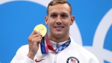 Gold medalist Caeleb Dressel of Team United States poses with the gold medal for the Men's 100m Butterfly Final at Tokyo Aquatics Centre on July 31, 2021 in Tokyo, Japan.