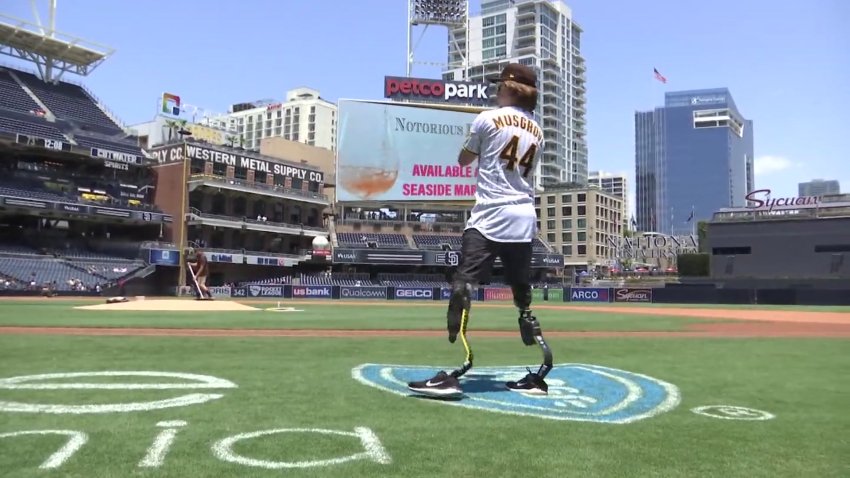 Landis Sims, 15, of Indiana plays catch with Padres' Joe Musgrove at Petco Park on Sunday, July 12, 2021.