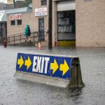 An exit sign sits in flood water