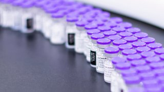 In this March 2021 photo provided by Pfizer, vials of the Pfizer-BioNTech COVID-19 vaccine are prepared for packaging at the company's facility in Puurs, Belgium. On Wednesday, Aug. 25, 2021, the company said it started the application process for U.S. approval of a booster dose of its two-shot COVID-19 vaccine for people ages 16 and older.