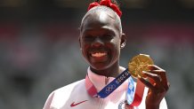 First-placed USA's Athing Mu celebrates on the podium with the gold medal after competing in the women's 800m event during the Tokyo 2020 Olympic Games at the Olympic Stadium in Tokyo on August 4, 2021.