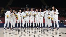 First placed USA's players pose for pictures with their gold medals after the medal ceremony for the women's basketball competition of the Tokyo 2020 Olympic Games at the Saitama Super Arena in Saitama on Aug. 8, 2021.