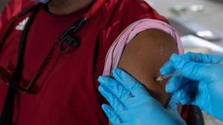 A patient receives his booster dose of the Pfizer-BioNTech coronavirus (COVID-19) vaccine during an Oakland County Health Department vaccination clinic at the Southfield Pavilion on August 24, 2021 in Southfield, Michigan.