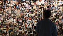 Désirée Bouchat looks at photos of those who perished, in a display at the 9/11 Tribute Museum