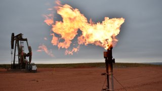 FILE - In this Aug. 26, 2021 file photo, a flare burns natural gas at an oil well Aug. 26, 2021, in Watford City, N.D. Consumers of natural gas are facing the prospect of much higher heating bills this winter. That's after enjoying a prolonged period of low prices.