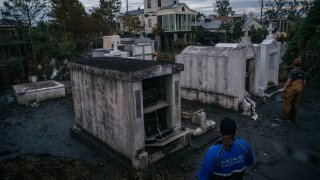 open caskets in a graveyard Hurricane Ida