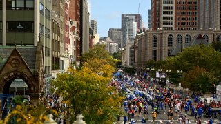 Runners near the finish line on Boylston Street during the 125th Boston Marathon on Monday, Oct. 11, 2021.