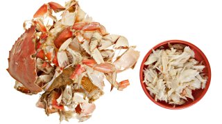 A whole fresh raw crab shelled with meat and shell left. Isolated on white.