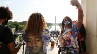 FILE - In this Aug. 28, 2020 file photo, Laurie Bey, right, whose son Cameron Lamb was shot and killed by Kansas City police in 2019, stands with Merlon Ragland, Cameron's aunt, as demonstrators gather at the Lincoln Memorial as final preparations are made for the March on Washington in Washington. The family of Lamb is suing Kansas City police and the officer. The Kansas City Star reports that the lawsuit was filed Monday, June 28, 2021, in federal court on behalf of 26-year-old Cameron Lamb's four minor children.