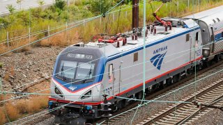 An Amtrak train departs 30th Street Station in Philadelphia, Wednesday, Oct. 27, 2021.