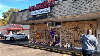 A memorial to slain rapper Young Dolph sits in front of the boarded windows at Makeda's Cookies on Thursday, Nov. 18, 2021, in Memphis, Tenn. Police said Young Dolph was fatally shot inside the popular Memphis