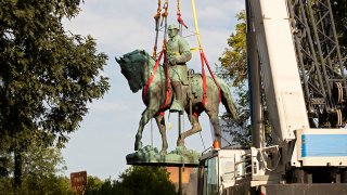 Workers remove the statue of Confederate General Robert E. Lee from a park in Charlottesville, Virginia, on July 10, 2021.