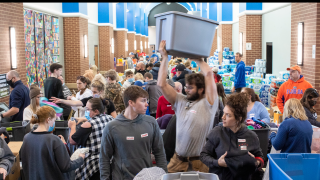 Red Cross volunteers work to drop off, sort and gather essential supplies from donations for people whose homes were destroyed or damaged by tornados at South Warren High School in Bowling Green, Ky., Sunday, Dec. 12, 2021.