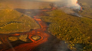 This photo released by the the National Galapagos Park communications office shows, from above, lava from the eruption of Wolf Volcano on Isabela Island, Galapagos Islands, Ecuador, Friday, Jan. 7, 2022.