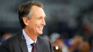 NBC broadcaster Cris Collinsworth looks on before an NFL football game between the Dallas Cowboys and the New York Giants in Arlington, Texas, Sunday, Sept. 16, 2018.