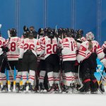 Canada players celebrate after a win against the United States during a preliminary round women's hockey game at the 2022 Winter Olympics, Feb. 8, 2022, in Beijing, China.