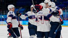 United States players celebrate after a goal by Kenny Agostino during a preliminary round men's hockey game against Canada at the 2022 Winter Olympics, Feb. 12, 2022, in Beijing.