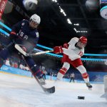 USA's Savannah Harmon, left, scores a goal past Russian Olympic Committee's goaltender Mariia Sorokina during the women's preliminary match for women's ice hockey at the Wukesong Sports Centre in Beijing, Feb. 5, 2022. The US shut out the ROC 5-0