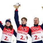 Team USA's Ashley Caldwell, Christopher Lillis and Justin Schoenefeld celebrate gold after the mixed team aerial skiing event at the Genting Snow Park as part of the 2022 Winter Olympic Games.