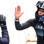 Kaillie Humphries of Team United States gives out a high five after finishing the Women's Monobob Bobsleigh Heat 3 on day 10 of 2022 Winter Olympics at National Sliding Centre on Feb. 14, 2022, in Yanqing, China.