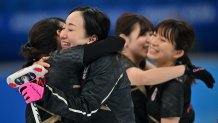 Yurika Yoshida, Satsuki Fujisawa, Chinami Yoshida and Yumi Suzuki celebrate their win during the 2022 Winter Olympic Games curling competition between USA and Japan at the National Aquatics Centre, Beijing, Feb. 16, 2022.