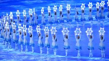 Performers hold up snowflakes with the names of participating countries in front of the large Olympic Rings during the Opening Ceremony of the Beijing 2022 Winter Olympics at the Beijing National Stadium on Feb. 4, 2022, in Beijing, China.