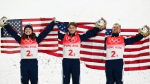 Gold medallists Ashley Caldwell, Christopher Lillis and Justin Schoenefeld of Team USA celebrates their gold medal win during the flower ceremony at Genting Snow Park, Feb. 10, 2022, in Zhangjiakou, Beijing.